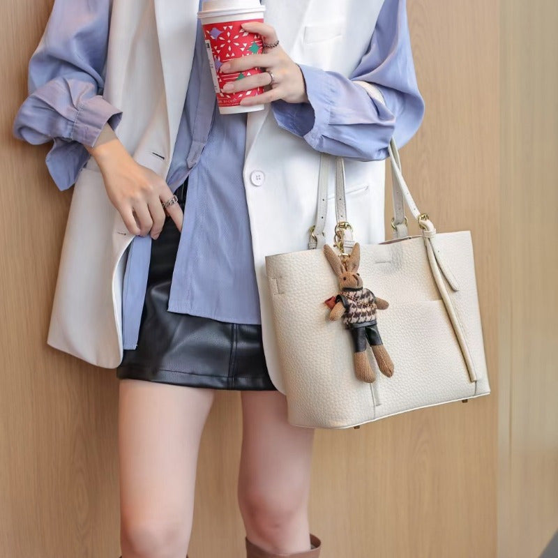 Gentle Beige Tote Bag, with a Playful Bear Charm, Demonstrating a Sweet Style