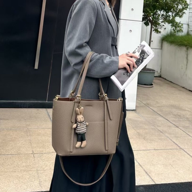 Gentle Beige Tote Bag, with a Playful Bear Charm, Demonstrating a Sweet Style