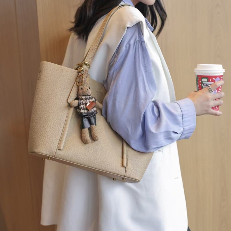 Gentle Beige Tote Bag, with a Playful Bear Charm, Demonstrating a Sweet Style
