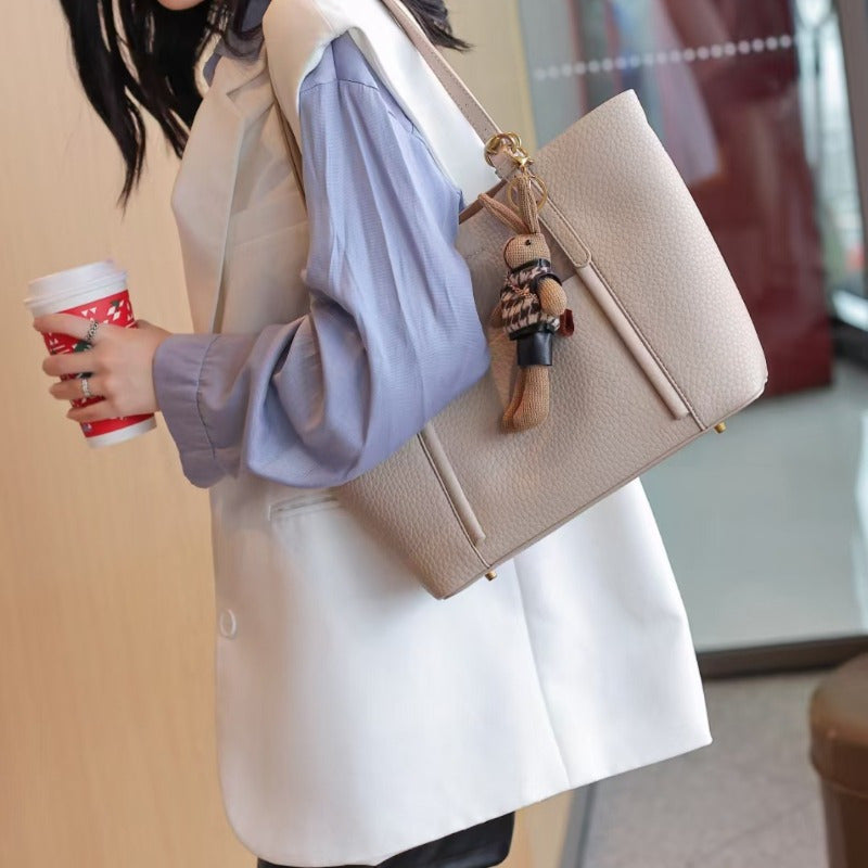 Gentle Beige Tote Bag, with a Playful Bear Charm, Demonstrating a Sweet Style